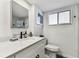 Bright bathroom features a modern vanity with white marble countertop and undermount sink at 620 Edgewater Dr # 204, Dunedin, FL 34698