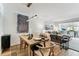 Dining room with wood floors open to living room, with art and contemporary lighting at 620 Edgewater Dr # 204, Dunedin, FL 34698
