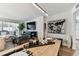 Dining room with wood floors open to living room and a bar area, with art and lighting at 620 Edgewater Dr # 204, Dunedin, FL 34698