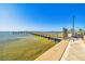 Scenic waterfront featuring a wooden dock, calm water, and open sky, offering a serene and relaxing environment at 620 Edgewater Dr # 204, Dunedin, FL 34698