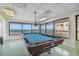 Game room with a pool table, ample natural light, and outdoor views at 620 Edgewater Dr # 204, Dunedin, FL 34698