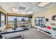 Exercise room with cardio machines, free weights, and a stunning ocean view at 620 Edgewater Dr # 204, Dunedin, FL 34698