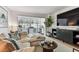 Comfortable living room with couch, tv, table, bar area, and large windows with natural light at 620 Edgewater Dr # 204, Dunedin, FL 34698