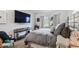 Main bedroom with a comfortable bed, accent chair, and modern fixtures at 620 Edgewater Dr # 204, Dunedin, FL 34698