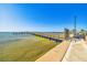 Scenic view of a wooden pier extending into the water, perfect for a relaxing walk at 620 Edgewater Dr # 204, Dunedin, FL 34698