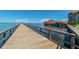 Picturesque pier extending into the tranquil water, offering a serene escape and scenic views at 620 Edgewater Dr # 204, Dunedin, FL 34698