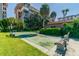 Outdoor shuffleboard courts surrounded by lush landscaping, perfect for leisure and recreation at 620 Edgewater Dr # 204, Dunedin, FL 34698