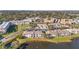 Community aerial view of the condo complex surrounded by beautiful mature trees and a large pond at 6311 99Th N Way # 11B, St Petersburg, FL 33708