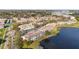Scenic aerial view of condo community with lake, mature trees, and community pool at 6311 99Th N Way # 11B, St Petersburg, FL 33708