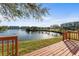 Backyard wooden deck overlooking serene lake and lush landscaping at 6311 99Th N Way # 11B, St Petersburg, FL 33708
