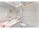 Clean bathroom with a tub/shower combo, decorative wallpaper, and ample counter space for a refreshing and stylish experience at 6311 99Th N Way # 11B, St Petersburg, FL 33708