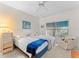 Bright bedroom featuring two twin beds, a ceiling fan, and a side chair, creating a comfortable and inviting space at 6311 99Th N Way # 11B, St Petersburg, FL 33708