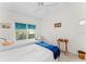 Bright bedroom featuring two twin beds, a ceiling fan, and large window with a view, creating a comfortable and relaxing atmosphere at 6311 99Th N Way # 11B, St Petersburg, FL 33708