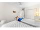 Bright bedroom featuring two twin beds, closet space, and a large window with a view, creating a comfortable and functional space at 6311 99Th N Way # 11B, St Petersburg, FL 33708