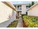 Well-maintained condo building featuring pleasant landscaping and inviting walkways at 6311 99Th N Way # 11B, St Petersburg, FL 33708