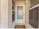 Inviting front door with sidelight windows and a 'Welcome' mat, adding charm to the home's entrance at 6311 99Th N Way # 11B, St Petersburg, FL 33708