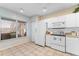 Well-lit kitchen featuring white appliances and tile flooring at 6311 99Th N Way # 11B, St Petersburg, FL 33708