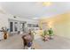 Bright and airy living room with seamless access to the kitchen and a view of the tiled entry at 6311 99Th N Way # 11B, St Petersburg, FL 33708