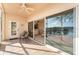 Covered patio with seating, offering scenic lake views through large sliding glass doors at 6311 99Th N Way # 11B, St Petersburg, FL 33708