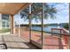 Enclosed lanai featuring outdoor living with panoramic waterfront views, tile flooring, and a ceiling fan at 6311 99Th N Way # 11B, St Petersburg, FL 33708