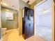 Bathroom view showcasing a tiled walk-in shower, vanity with cabinet, and entryway to bedroom at 634 Allegheny Dr, Sun City Center, FL 33573