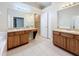 Bathroom featuring double vanities, mirrors, tile flooring, and walk-in shower at 7541 Mariners Harbour Dr, Wesley Chapel, FL 33545