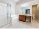 Bathroom with a tub, glass-enclosed shower, and a wood vanity with double sinks at 7541 Mariners Harbour Dr, Wesley Chapel, FL 33545