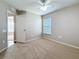 Neutral bedroom features carpet, a ceiling fan, and a window with natural light at 7541 Mariners Harbour Dr, Wesley Chapel, FL 33545