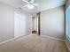 Neutral bedroom featuring carpet, a ceiling fan, a closet, and a window with natural light at 7541 Mariners Harbour Dr, Wesley Chapel, FL 33545