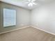 Bedroom with a window, neutral walls, and carpeted flooring at 7541 Mariners Harbour Dr, Wesley Chapel, FL 33545
