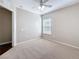 Bedroom with a window, neutral walls, carpeted flooring, and a door at 7541 Mariners Harbour Dr, Wesley Chapel, FL 33545