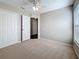 Bedroom with closet, neutral walls, carpet, window, and white trim at 7541 Mariners Harbour Dr, Wesley Chapel, FL 33545