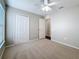 Bright bedroom with carpeted floors, a closet, and direct access to a hallway at 7541 Mariners Harbour Dr, Wesley Chapel, FL 33545