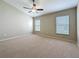 Bedroom featuring neutral paint, carpeting, two windows, and a ceiling fan at 7541 Mariners Harbour Dr, Wesley Chapel, FL 33545