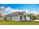 Well-maintained home with lush lawn, showcasing landscaping and architectural features at 7541 Mariners Harbour Dr, Wesley Chapel, FL 33545