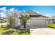 Charming single-story home featuring a two-car garage and well-manicured front yard at 7541 Mariners Harbour Dr, Wesley Chapel, FL 33545