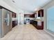 Open kitchen boasts stainless appliances, granite counters, and dark wood cabinetry at 7541 Mariners Harbour Dr, Wesley Chapel, FL 33545