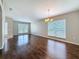 Inviting living area featuring hardwood floors, neutral walls, and views of the outdoors at 7541 Mariners Harbour Dr, Wesley Chapel, FL 33545