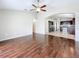 Open-concept living room with wood floors that connects to the kitchen at 7541 Mariners Harbour Dr, Wesley Chapel, FL 33545