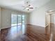 Bright living room with ceiling fan and sliding glass doors to the patio at 7541 Mariners Harbour Dr, Wesley Chapel, FL 33545