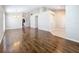 Open-concept living area featuring hardwood floors and decorative archways into other rooms at 7541 Mariners Harbour Dr, Wesley Chapel, FL 33545