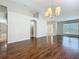 Spacious living room with hardwood floors, a ceiling fan, and ample natural light at 7541 Mariners Harbour Dr, Wesley Chapel, FL 33545
