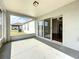 Screened patio with access to the interior through sliding glass doors at 7541 Mariners Harbour Dr, Wesley Chapel, FL 33545