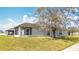 The back exterior of the home features a screened in lanai and spacious lawn at 7541 Mariners Harbour Dr, Wesley Chapel, FL 33545