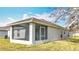 View of the home's rear exterior showing a screened lanai and stucco siding at 7541 Mariners Harbour Dr, Wesley Chapel, FL 33545