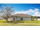 Rear exterior of the home showing the yard and screened in lanai at 7541 Mariners Harbour Dr, Wesley Chapel, FL 33545