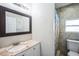 Bathroom with marble countertop, large mirror and bath/shower combo at 822 W Kirby St, Tampa, FL 33604