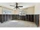 Bare bedroom with a ceiling fan, two windows, and black mold in the walls at 921 39Th Ne Ave, St Petersburg, FL 33703