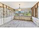 Bright sunroom featuring large windows, framing and flooring awaiting transformation into a cozy retreat at 921 39Th Ne Ave, St Petersburg, FL 33703