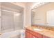 Bathroom features granite countertops, a large mirror, and a shower and tub combination at 13304 Sanctuary Cove Dr # 303, Temple Terrace, FL 33637